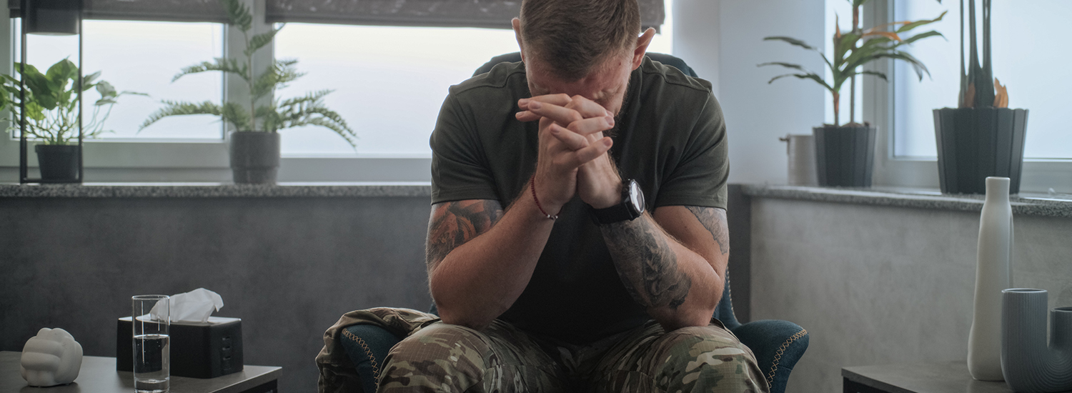 man with head in hands in anguish