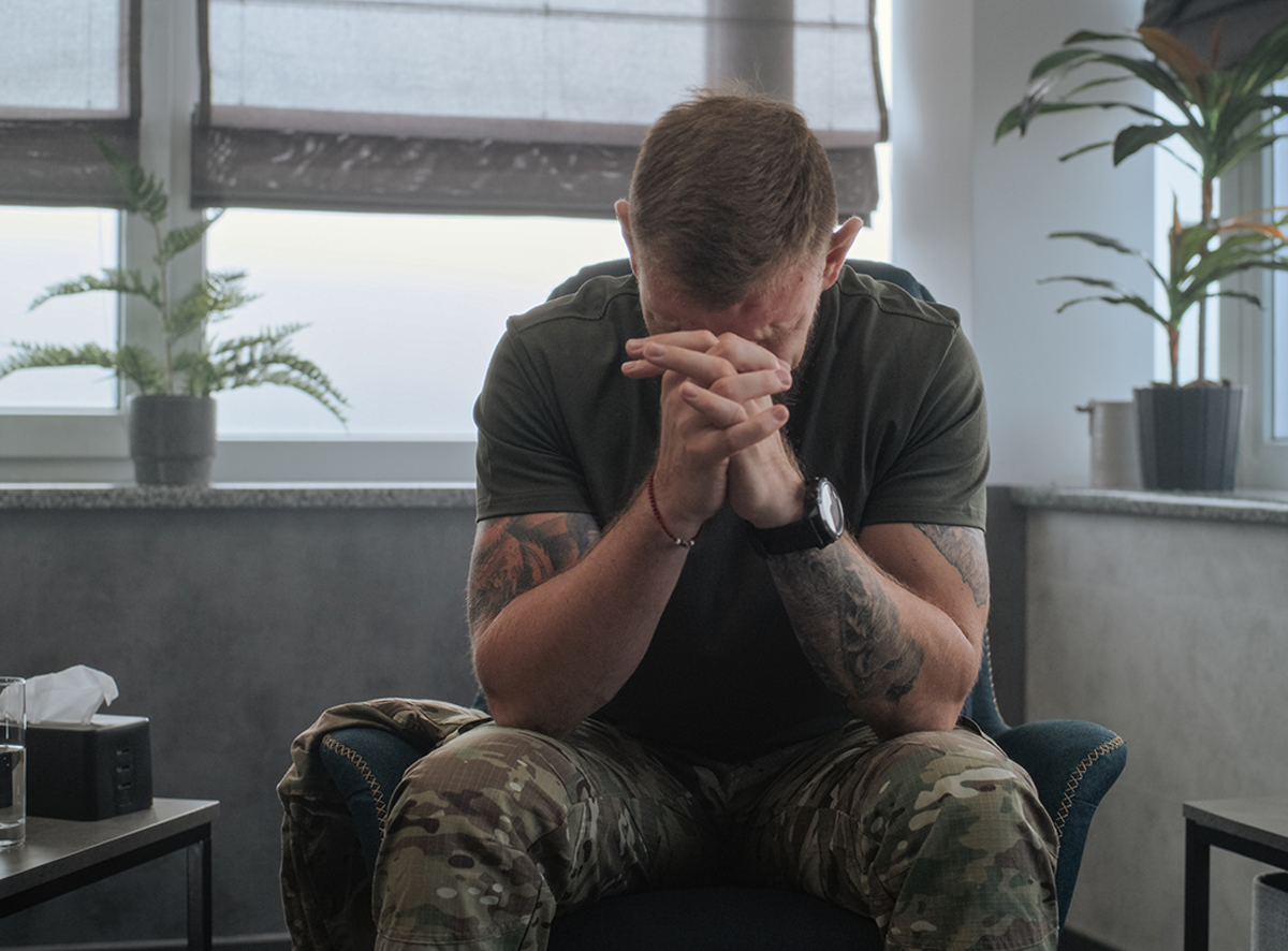 man with head in hands in anguish
