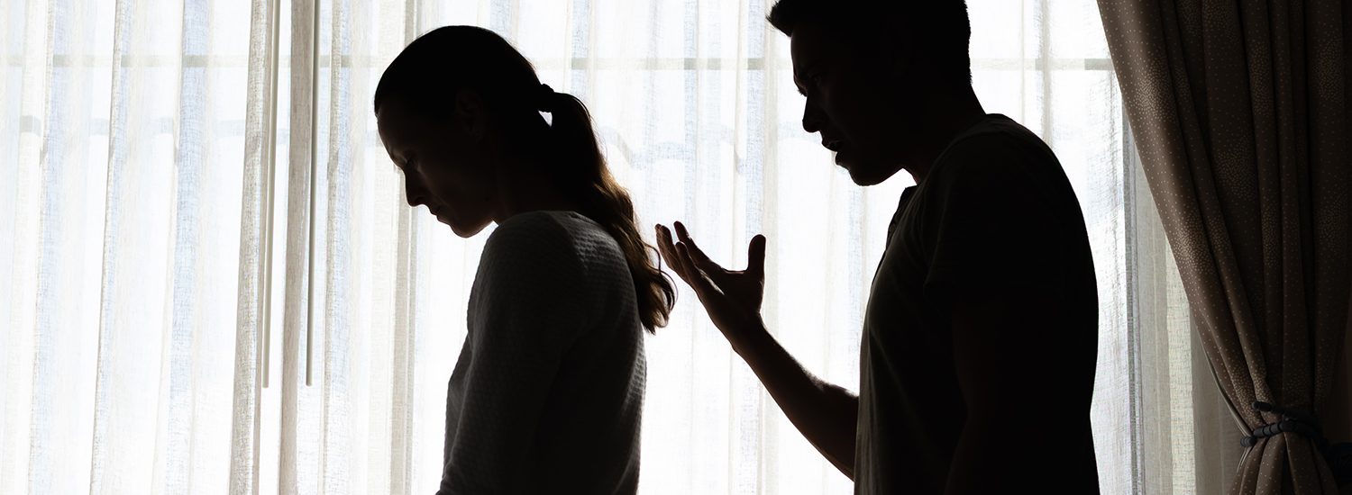 woman cowering from man yelling